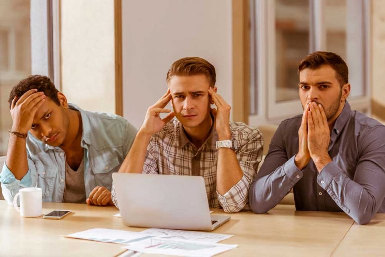 three young businessmen working looking worried about brand crisis